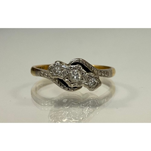 306 - A diamond twist ring, set with three graduated old round brilliant cut diamonds, total estimated dia... 