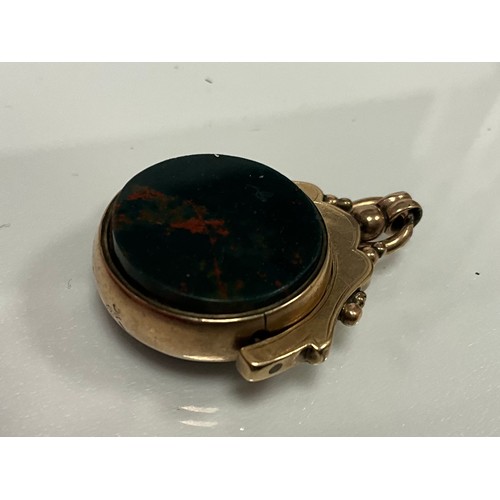 312 - An early 20th century swivel fob bloodstone and carnelian matrixes, indistinctly marked yellow metal... 