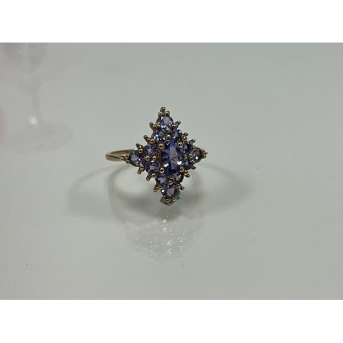 317 - A 9ct yellow gold dress ring set with round and oval tanzanites and small diamonds. Tanzanites 1.00c... 