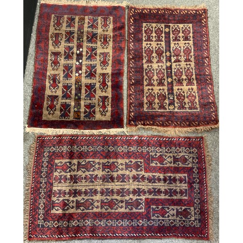 238 - A mid 20th century Afghan type woollen rug, knotted in tones of red, deep blue, and grey, 120cm x 76... 