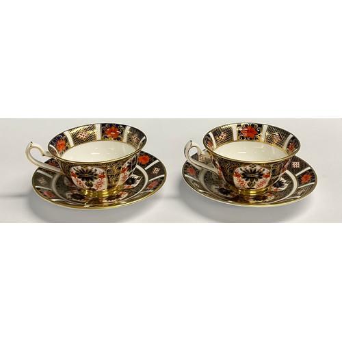 25 - A pair of Royal Crown Derby Imari 1128 pattern tea cups and saucers, printed marks, first quality