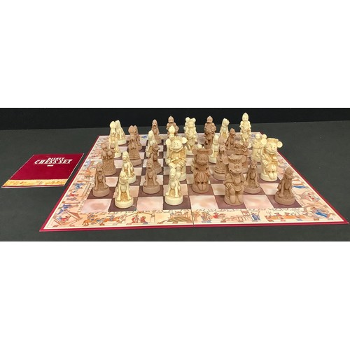 129 - A novelty Disney chess set and folding board, the pieces as Mickey Mouse and companions, unpainted, ... 