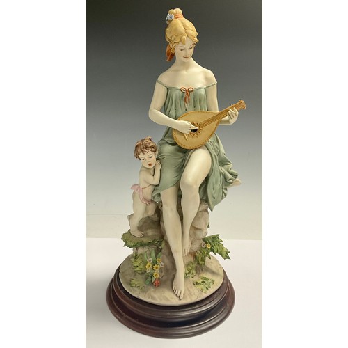 78 - An Italian Naples figure, signed Benacchio, The Lute Player, scantily clad lady with putto companion... 