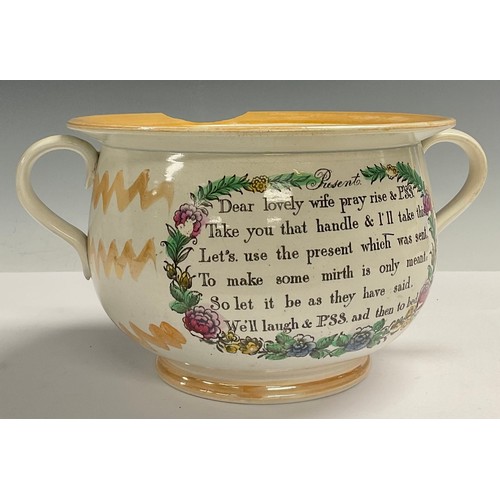 98 - An English lustre pottery marriage chamber pot, printed with verse, the interior with caricature and... 