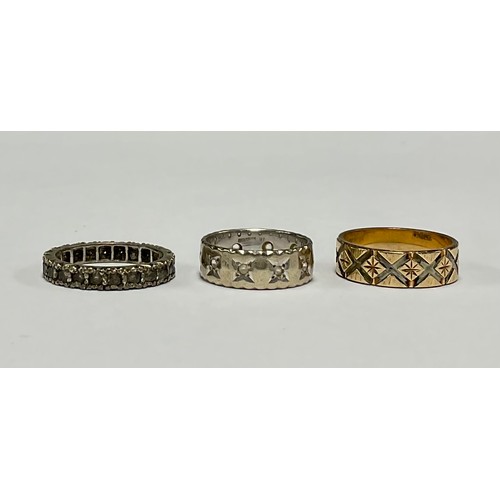 190 - A 9ct gold ring, engraved with bright cut diamond shapes; another, white gold; another, similar (3)