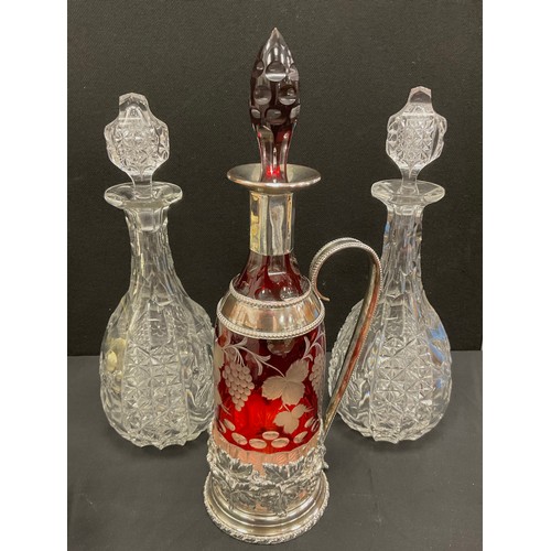 7 - A ruby flashed clear glass claret jug decanter, silver plated embossed floral mounts and handle;  a ... 