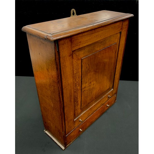 20 - A 19th century oak apothecary or spice wall hangling cabinet, slide up panel door above single base ... 