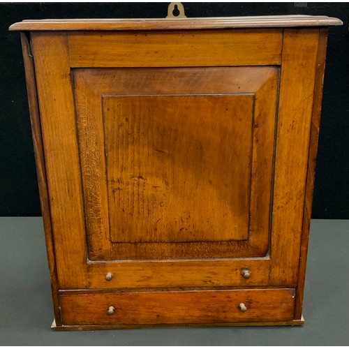 20 - A 19th century oak apothecary or spice wall hangling cabinet, slide up panel door above single base ... 