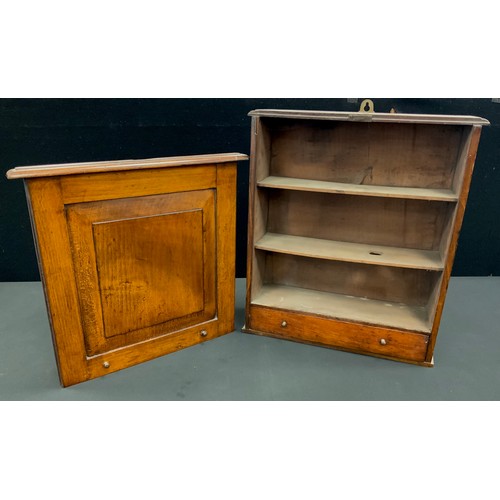 20 - A 19th century oak apothecary or spice wall hangling cabinet, slide up panel door above single base ... 