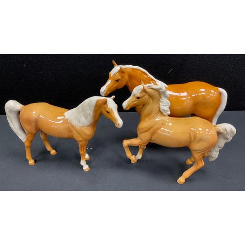 33 - Beswick Palomino Race Horse, 19cm high, Prancing Palomino Horse, 16cm high, other (3)