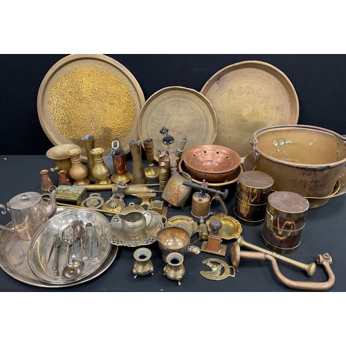 59 - Brass ware including - early 20th century planished brass chargers, jam pans, copper and brass caddi... 