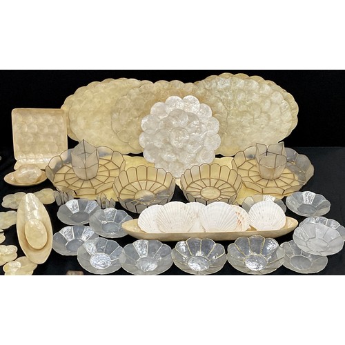 60 - A set of nine oyster shell placemats, 45cm long, conforming six coaster and oval and square dishes; ... 