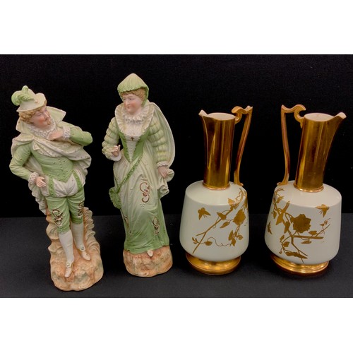 17 - A pair 19th century Worcester style ewers, 32cm high; a pair of Bisque figures (4)