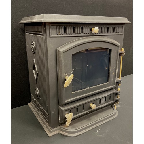 77 - A cast iron log burner, heat output 8kw, 85kg, 39cm high