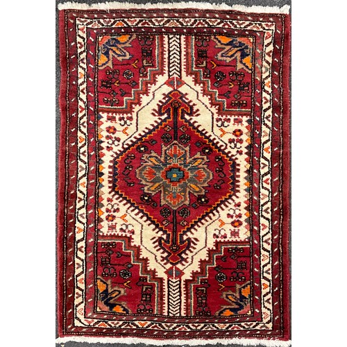 97 - A Persian Shiraz type rug / carpet, hand-knotted in deep red, indigo, turquoise, orange, and white, ... 