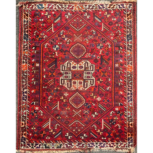 101 - A Persian Shiraz type woollen rug / carpet, hand-knotted in tones of blue, white, orange, and indigo... 