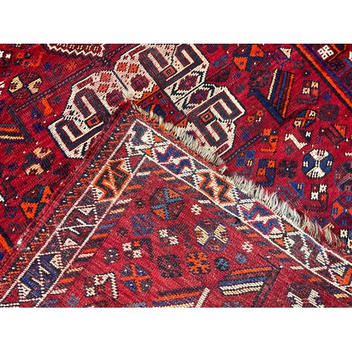 101 - A Persian Shiraz type woollen rug / carpet, hand-knotted in tones of blue, white, orange, and indigo... 