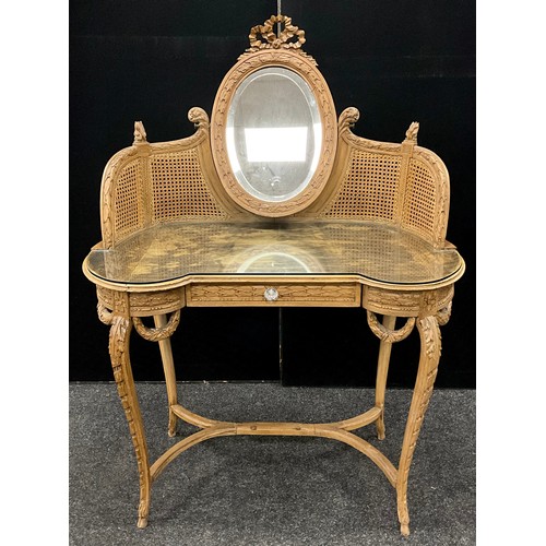 115 - A French Louis XV style carved oak dressing table, bergere weave super-structure supporting an oval ... 