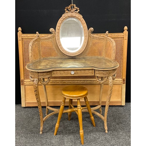 115 - A French Louis XV style carved oak dressing table, bergere weave super-structure supporting an oval ... 