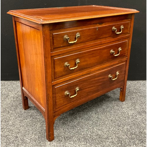 123 - An early 20th century chest of three graduated drawers, of small proportions, brass swan-neck handle... 