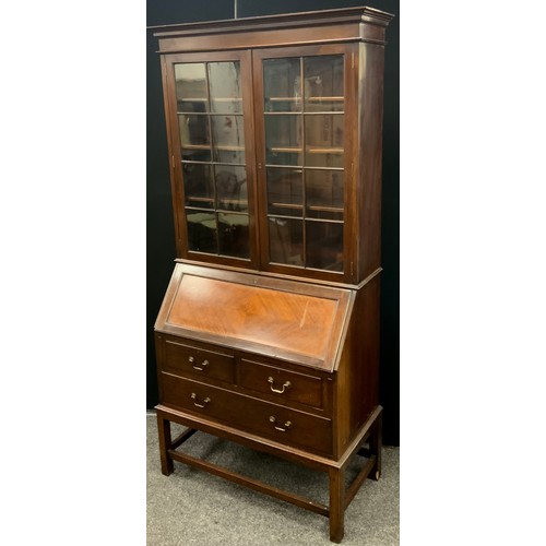 138 - An early 20th century mahogany bureau bookcase, the moulded cornice above pair of astral-glazed door... 