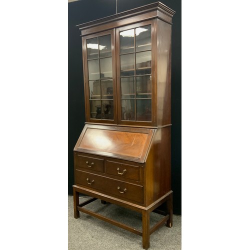 138 - An early 20th century mahogany bureau bookcase, the moulded cornice above pair of astral-glazed door... 