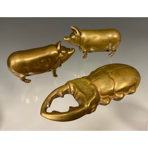 169 - Two Victorian novelty brass so-to-bed vestas, each in the form of a pig, 5cm long; another vesta as ... 