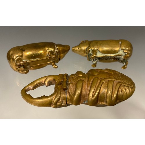 169 - Two Victorian novelty brass so-to-bed vestas, each in the form of a pig, 5cm long; another vesta as ... 