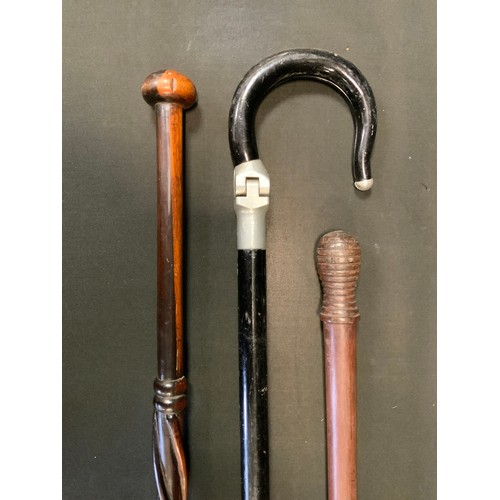 185 - A late 19th century cane, ring turned pommel. 92cm high;  an ebonised shooting stick;  a wrythen can... 