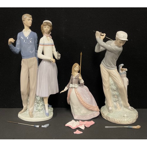 94 - A Lladro figure group, Golfing Couple, number 1453, 34cm; others, Golfer, 29cm; Girl, 5211 (3)