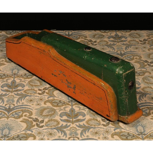 606 - Folk Art - a 1930's painted wooden carpet toy, in the form of a streamlined locomotive, painted in o... 