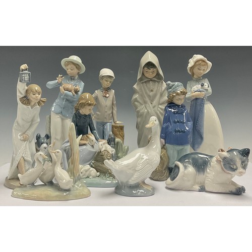 613 - A Spanish porcelain Nao figure, Girl with Puppy, 25cm; Boy With Puppy; kitten; goose; Boy In Duffel ... 