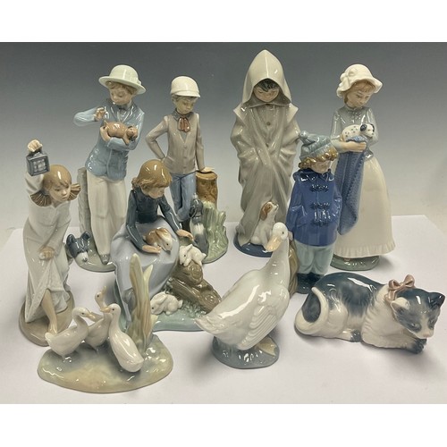 613 - A Spanish porcelain Nao figure, Girl with Puppy, 25cm; Boy With Puppy; kitten; goose; Boy In Duffel ... 