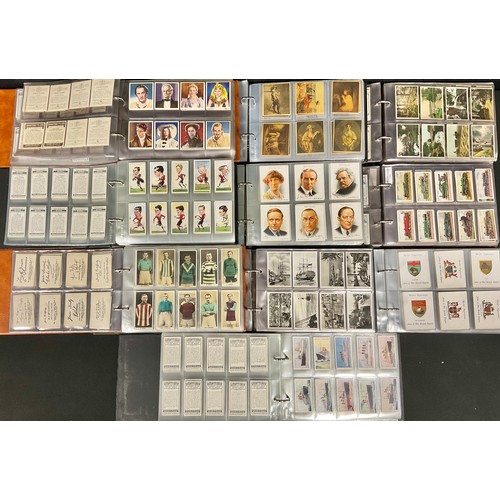 634 - A large quantity of cigarette cards in full and part sets across ten albums, including Pattreiouex, ... 