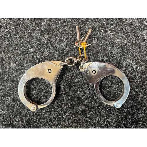 2407 - Pair of British Police issue Handcuffs. Marked 