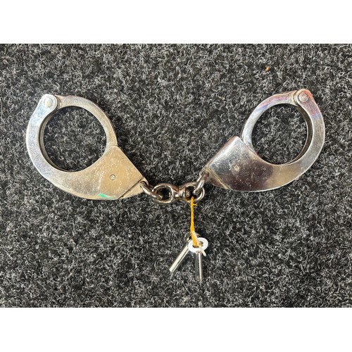 2407 - Pair of British Police issue Handcuffs. Marked 