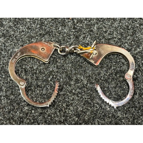 2407 - Pair of British Police issue Handcuffs. Marked 