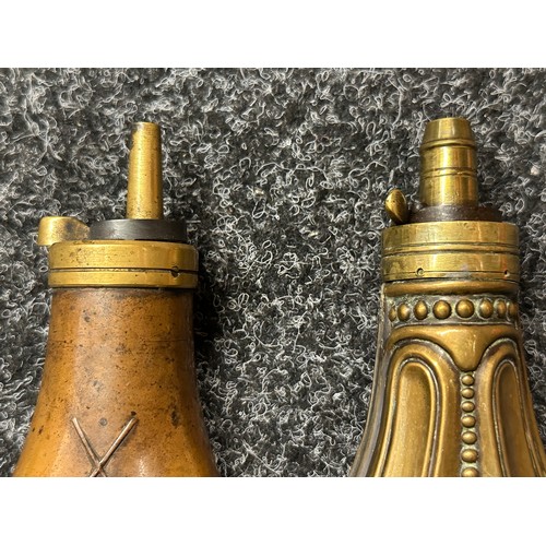 2419 - Pair of Powder Flasks, both un-marked. One with piled Arms design and non adjustable nozzle. The oth... 