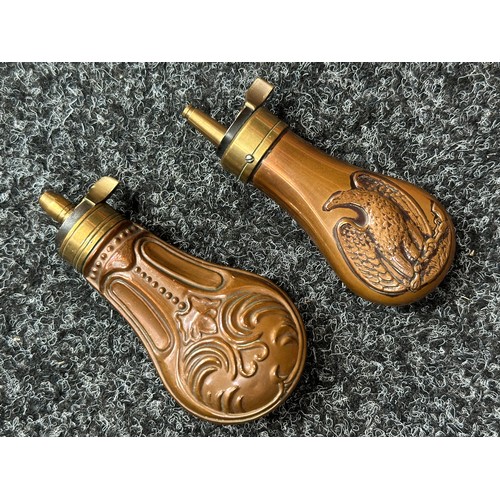 2422 - Pair of Copper Pistol Powder Flasks. One unmarked with a embossed floral design 110mm in length. The... 