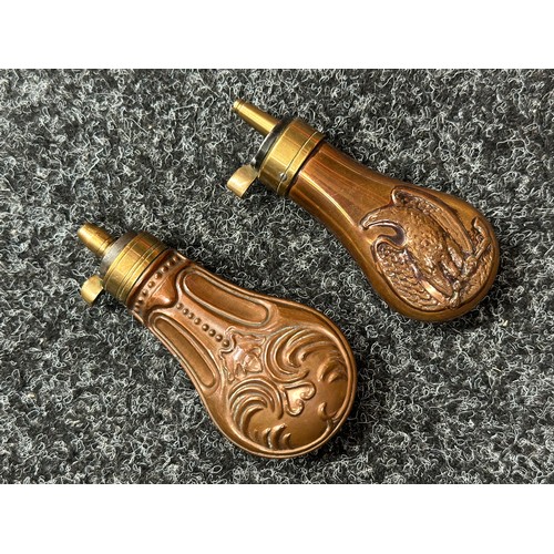 2422 - Pair of Copper Pistol Powder Flasks. One unmarked with a embossed floral design 110mm in length. The... 