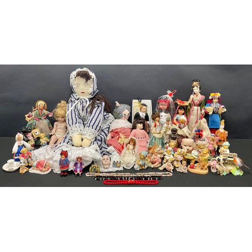 661 - A cold painted lead doll, as a Welsh Lady, signed, 25cm; a bisque doll's head; other dolls; a canon;... 