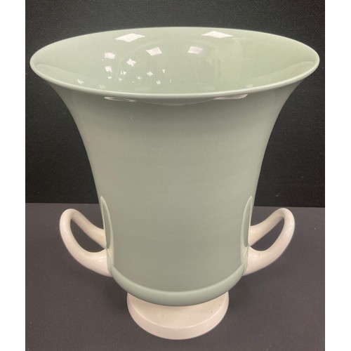 12 - A large Wedgwood twin handled pedestal urn designed by Keith Murray decorated in a pale celadon and ... 