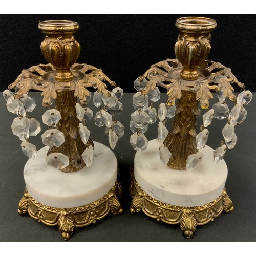 20 - A pair of marble base gilt metal candlesticks, baroque decoration with branches of descending glass ... 