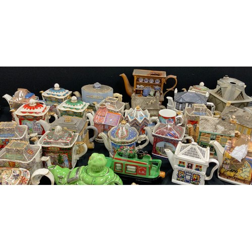 68 - Novelty tea pots including; Faulty Towers, Coronation Street, Sadler; others (approx.25)