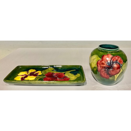 4 - A Moorcroft Hibiscus pattern ovoid vase, tube lined with large flowerheads on a green ground, 10cm, ... 