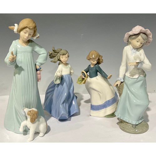 40 - A Nao by Lladro figure, 'Bad Boy', 25.5cm high; others, Girl with Dove, Girl with Basket of Flowers,... 