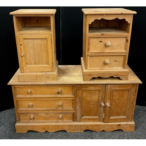 103 - A Pine low side cabinet, over-sailing rectangular top, above three long drawers, and a pair of cupbo... 