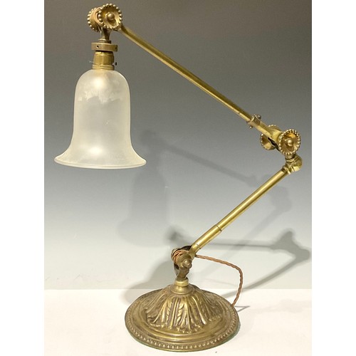 61 - An early 20th century brass adjustable desk lamp, domed circular base embossed with acanthus, froste... 