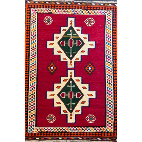 114 - A South West Persian Qashgai Kilim rug, two multi-coloured medallions, red ground, 240cm x 160cm