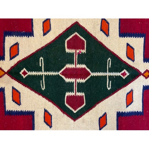 114 - A South West Persian Qashgai Kilim rug, two multi-coloured medallions, red ground, 240cm x 160cm